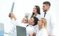 Group of doctors discussing an x-ray , sitting at the table.