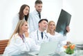 Group of doctors discussing an x-ray ,sitting at the table.