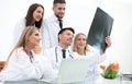 Group of doctors discussing an x-ray ,sitting at the table.