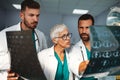 Group of doctors examining an x-ray in hospital to make diagnosis Royalty Free Stock Photo