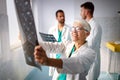 Group of doctors examining an x-ray in hospital to make diagnosis Royalty Free Stock Photo