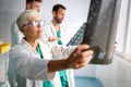 Group of doctors examining an x-ray in hospital to make diagnosis Royalty Free Stock Photo