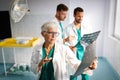 Group of doctors examining an x-ray in hospital to make diagnosis Royalty Free Stock Photo