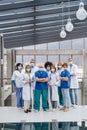 Group of doctors with face masks looking at camera, corona virus concept.