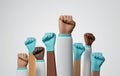 Group doctors holding fists together on white background