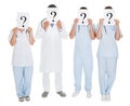 Group Of Doctors Holding Question Mark Sign