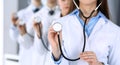 Group of doctors holding stethoscope head close-up. Physicians ready to examine and help patient. Medical help Royalty Free Stock Photo