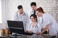 Group Of Doctors Looking At Computer