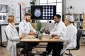 Group of doctors looking at screen with brain CT at hospital Royalty Free Stock Photo