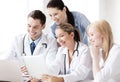 Group of doctors looking at tablet pc