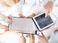 Group of doctors looking at x-ray on tablet pc Royalty Free Stock Photo