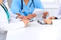 Group of doctors at medical meeting. Close up of physician using tablet computer. Royalty Free Stock Photo