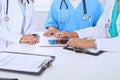 Group of doctors at medical meeting. Close up of physician using touch pad or tablet computer Royalty Free Stock Photo