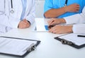 Group of doctors at medical meeting. Close up of physician using touch pad or tablet computer Royalty Free Stock Photo