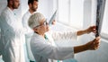 Group of doctors examining an x-ray in hospital to make diagnosis Royalty Free Stock Photo