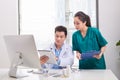 Group of doctors and nurses examining medical report of patient. Team of doctors working together on patients file at hospital Royalty Free Stock Photo