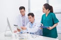 Group of doctors and nurses examining medical report of patient. Team of doctors working together on patients file at hospital Royalty Free Stock Photo