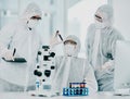 Group of doctors and scientists conducting medical research on viruses dressed in hazmat suits, for coronavirus cure in Royalty Free Stock Photo