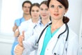 Group of doctors showing OK or approval sign with thumb up. High level and quality medical service, best treatment and Royalty Free Stock Photo