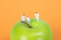 Group of doctors sitting on a green apple