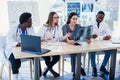 Group of doctors are studying disease patient`s history. Team of multiethnic young doctors having a meeting in Royalty Free Stock Photo