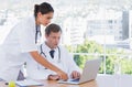 Group of doctors working together on a laptop Royalty Free Stock Photo