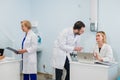 Group of doctors working together on a laptop in a modern office Royalty Free Stock Photo