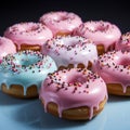 a group of donuts with pink frosting and sprinkles