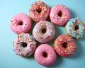 a group of donuts with sprinkles on a blue background