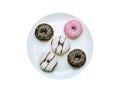 A group of doughnut items on a light plate. Isolated on a white background, top view Royalty Free Stock Photo