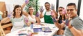 Group of draw students sitting on the table showing painted palm hands at art studio Royalty Free Stock Photo