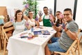 Group of draw students sitting on the table showing painted palm hands at art studio Royalty Free Stock Photo