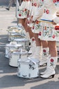 Group of drummer girls in white Ukrainian costumes with traditional red ornament