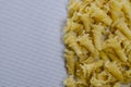 Group Dry Gigli or campanelle pasta on a white textured background Royalty Free Stock Photo