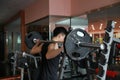 Fitness man in the gym doing squat . Man with dumbbell weight training equipment gym. Indoor, instructor. Royalty Free Stock Photo