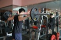 Fitness man in the gym doing squat . Man with dumbbell weight training equipment gym. Indoor, instructor. Royalty Free Stock Photo