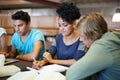 Group, education and students writing in notes studying for exam or learning information in classroom. University Royalty Free Stock Photo