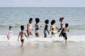 Group of eight boys and girls running to sea water, cute kids having fun on sandy summer beach, happy childhood friend playing on Royalty Free Stock Photo