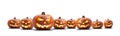 A group of eight lit spooky halloween pumpkins, Jack O Lantern with evil face and eyes