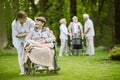 Elder people and nurse taking care of them