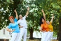 Group of elderly people, man and women training together outdoors on warm summer morning, doing exercises Royalty Free Stock Photo