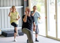 Group of elderly senior people practicing Tai chi class in age care gym facilities Royalty Free Stock Photo