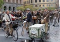 Group of elegant cycling people wearing old fashioned tweed clothes