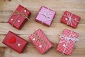 Group of elegant red gift box stack decorated with mini heart figure on wood background, vibrant valentine lovely present concept Royalty Free Stock Photo