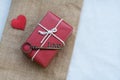 Group of elegant red gift box stack decorated with mini heart figure on wood background, vibrant valentine lovely present concept Royalty Free Stock Photo