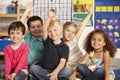 Group Of Elementary Age Schoolchildren Answering Question In Class Royalty Free Stock Photo