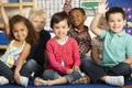 Group Of Elementary Age Schoolchildren Answering Question In Class Royalty Free Stock Photo