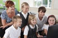 Group Of Elementary Pupils In Computer Class With Teacher