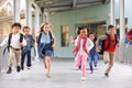 Group of elementary school kids running in a school corridor Royalty Free Stock Photo