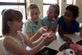 Group of elementary school kids working with anatomy model